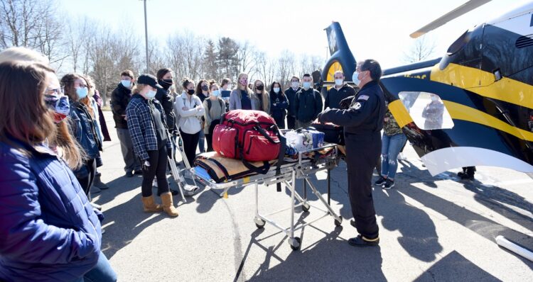 Paramedic Michael Yee, an employee of STAT MedEvac, talks to students in Butler County Community College’s Nursing, R.N., program March 2 about equipment inside the Airbus EC-135 STAT MedEvac helicopter.