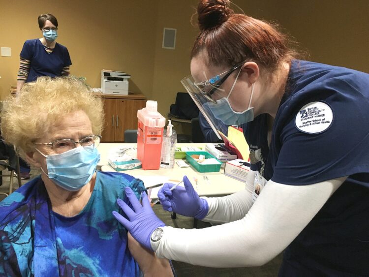 Mackenzie Dean, of Dayton, a student in Butler County Community College’s Nursing, R.N., program, administers a COVID-19 vaccination to Patricia Nunamaker, 89, of Cabot, at Butler Memorial Hospital’s COVID-19 clinic Feb. 23.  More than 80 BC3 registered nursing students from four counties are gaining once-in-a-lifetime experience by serving  the community as volunteers at the clinic that inoculates up to 1,200 visitors a day.