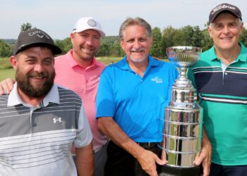 This is a portrait of the NexTier team at BC3 Education Foundation golf outing. There are four golfers. One is holding a trophy.
