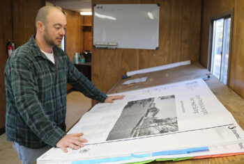 man looks at bc3 construction site plans