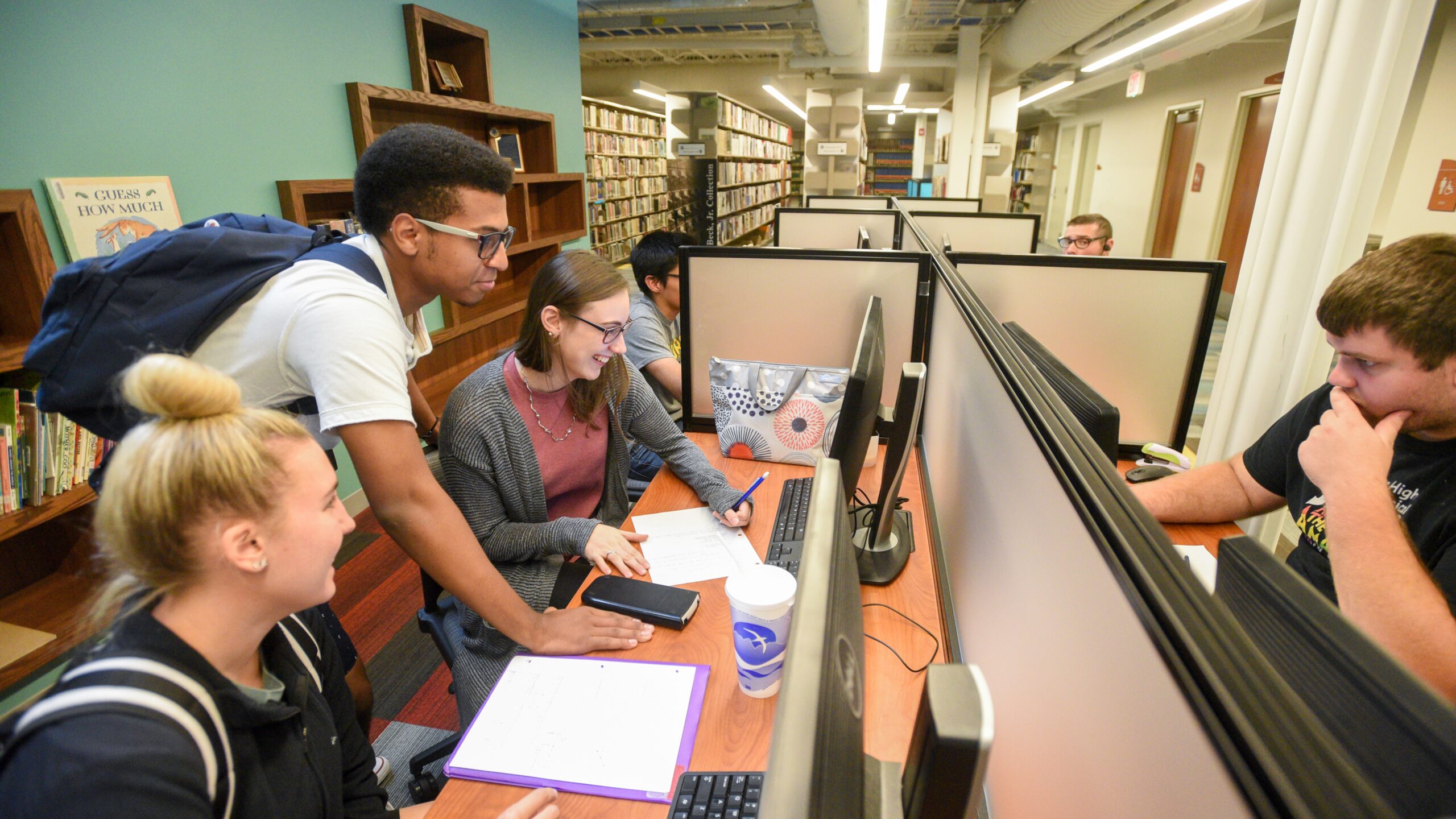 Students studying at a computer in the library.