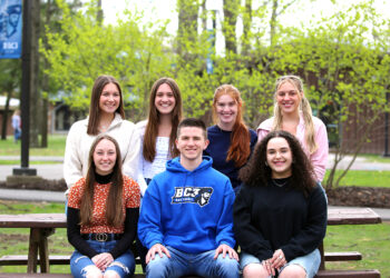 photo of students in outdoor setting smiling