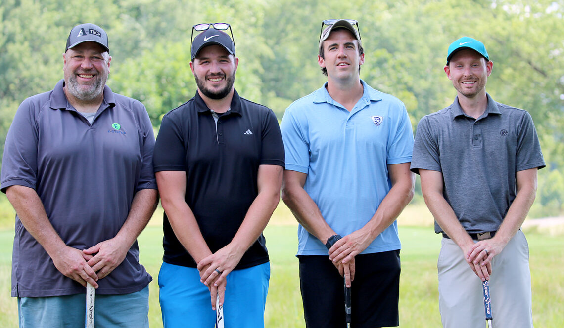 group of four male golfers on golf course