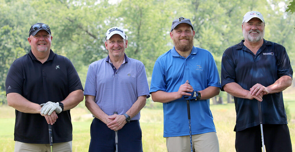 group of four male golfers on golf course